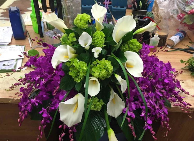 Lovely purple, green and white flowers in a large arrangement