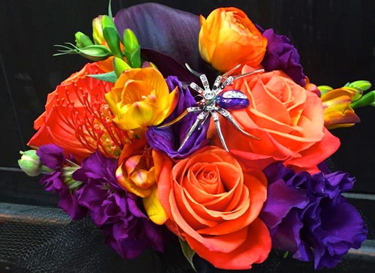 A vibrant orange, purple and yellow bouquet